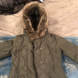 Woman’s winter jacket with faux fur hood